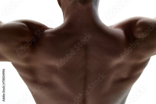 Cropped photo of healthy muscled man's back against white background. Naked male torso seen from behind. Concept of natural beauty, aesthetic of body, male health, masculinity.