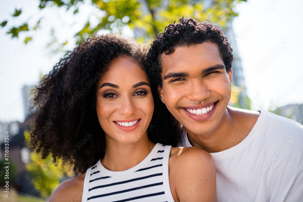 Photo of positive cheerful two people buddies smiling enjoying summer vacation outside city Photo of positive cheerful two people buddies smiling enjoying summer vacation outside city