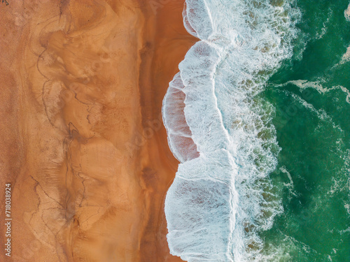 Ocean Dance: A Captivating Aerial Perspective of São Martinho do Porto's Azure Waves and Golden Sands photo