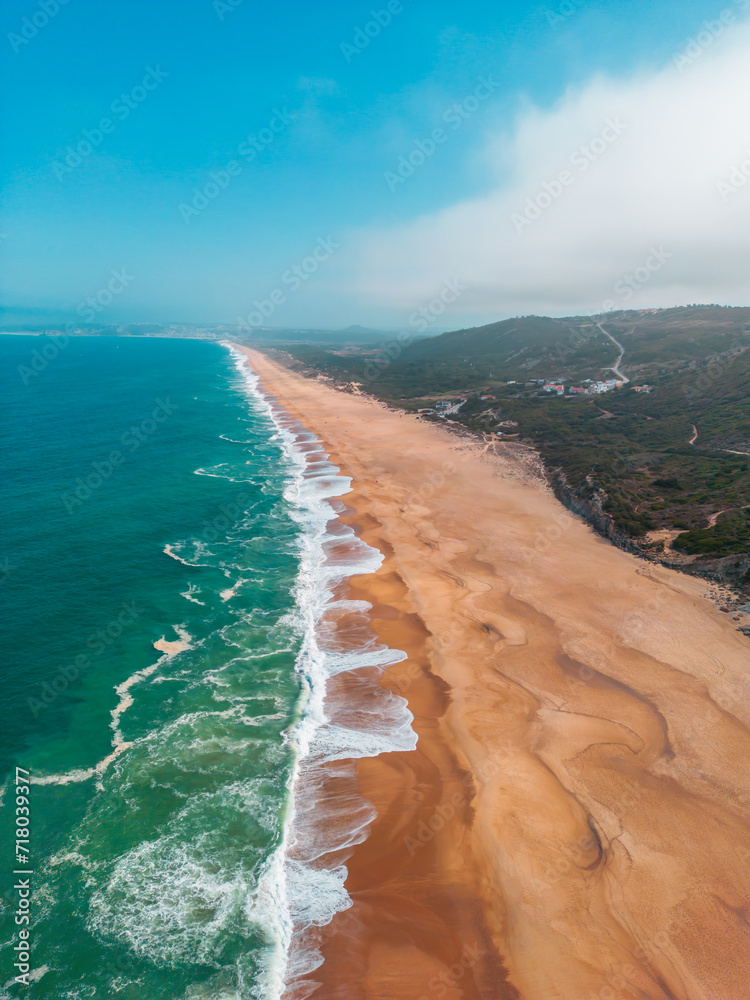 Ocean Dance: A Captivating Aerial Perspective of São Martinho do Porto's Azure Waves and Golden Sands