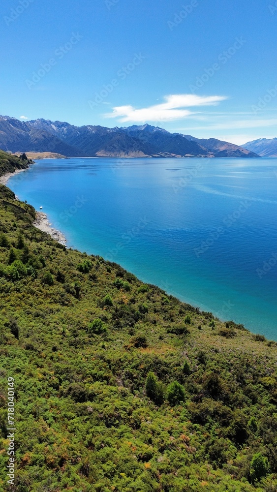 Aerial view of Lake Hawea surrounded by lush greenery. New Zealand