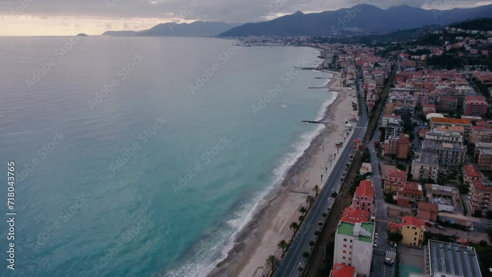 Drone shot of the sea, beach and mountains all in one composition in Pietra Ligure, winter time, Italy Drone shot of the sea, beach and mountains all in one composition in Pietra Ligure, winter time, Italy