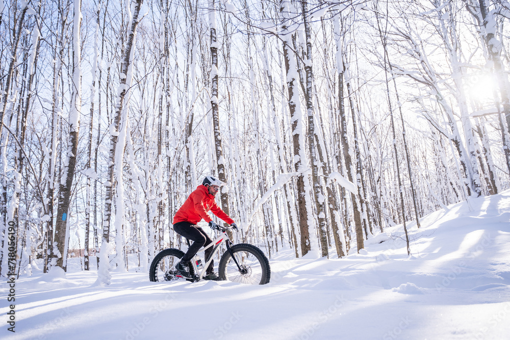 Fat biker riding his bicycle in the snow during Canadian winter