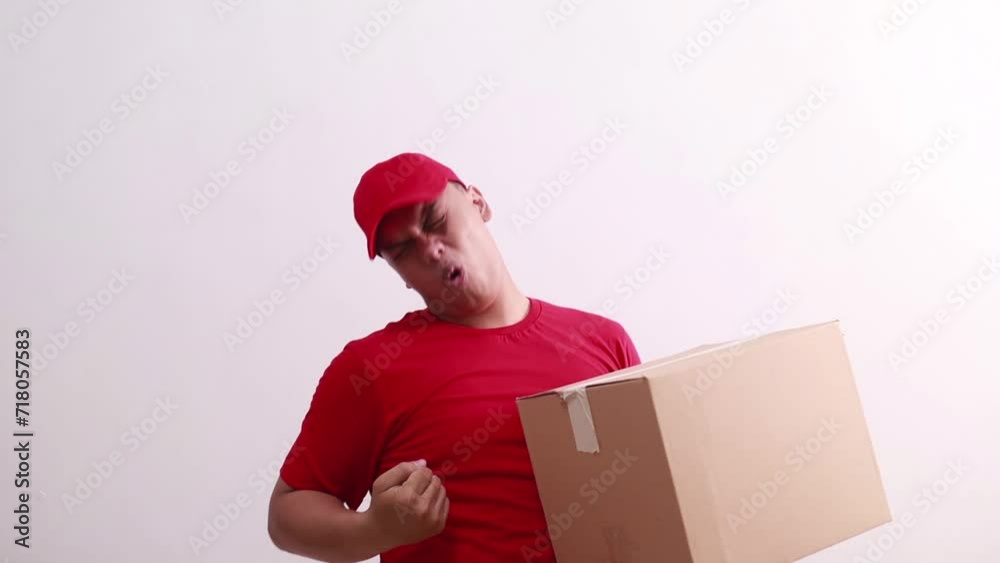 Wow amazed young asian courier man holding a cardboard with fist hands