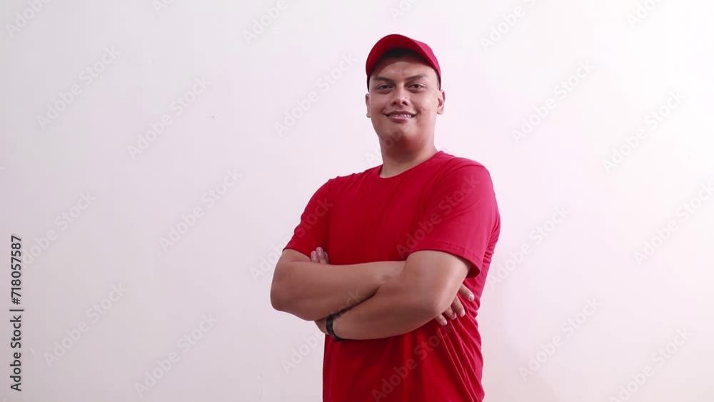 Confident young asian courier man standing while smiling and looking at the camera