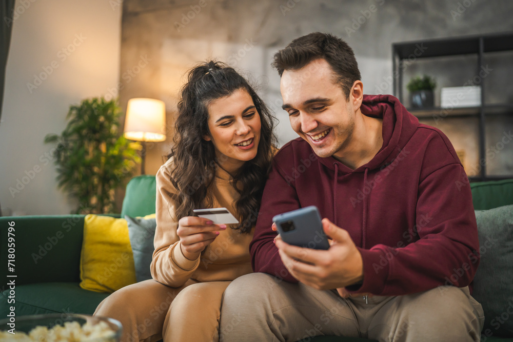 adult happy couple man and woman shopping online hold credit card adult happy couple man and woman shopping online hold credit card