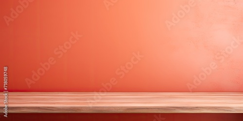 Coral-colored abstract wall background with empty wooden table. Ideal for product display or montage.