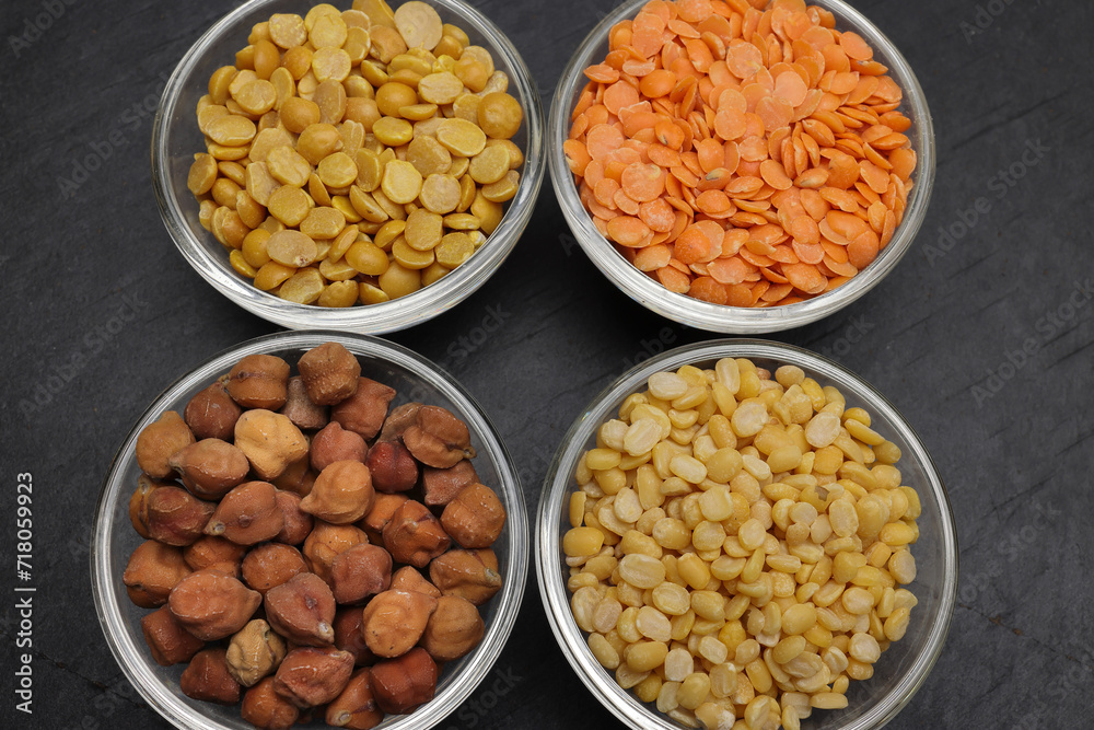 variety of lentils pulses red masoor mung dal yellow split chickpeas pigeon peas in mini glass bowl on black slate background variety of lentils pulses red masoor mung dal yellow split chickpeas pigeon peas in mini glass bowl on black slate background