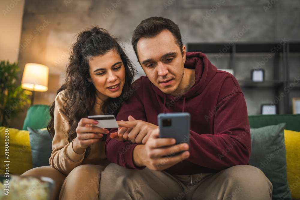 adult happy couple man and woman shopping online hold credit card adult happy couple man and woman shopping online hold credit card