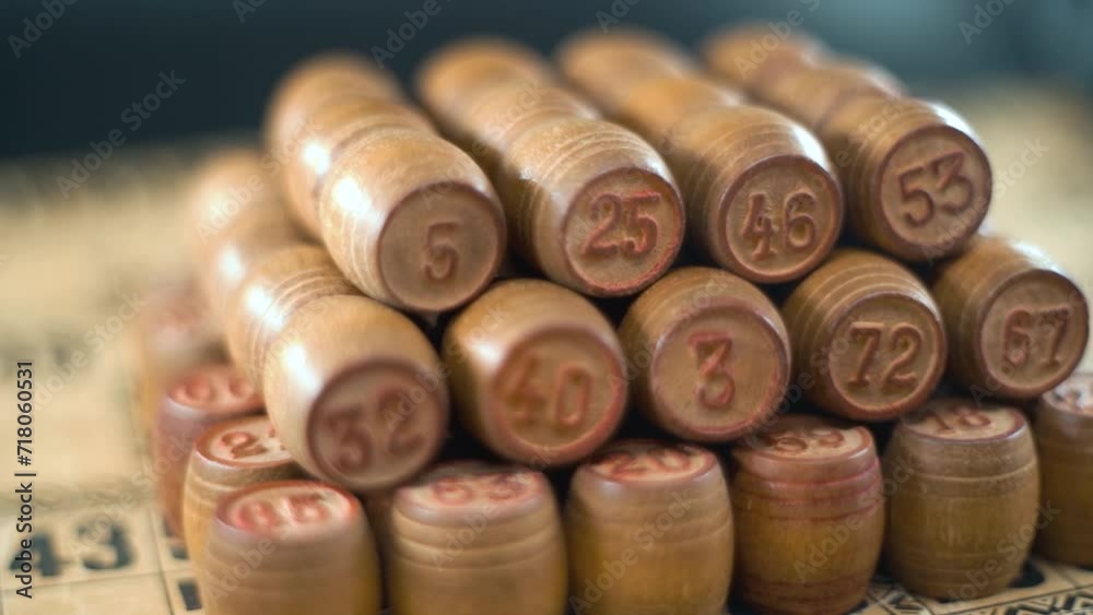 Cinematic creative smooth dreamy macro shot of Bingo wooden barrels in a row, woody figures, old numbers background, vintage board game, slow motion 120 fps commercial gimbal video, crane movement Cinematic creative smooth dreamy macro shot of Bingo wooden barrels in a row, woody figures, old numbers background, vintage board game, slow motion 120 fps commercial gimbal video, crane movement