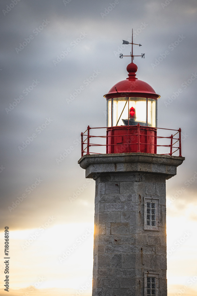 lighthouse with red colors at sunset