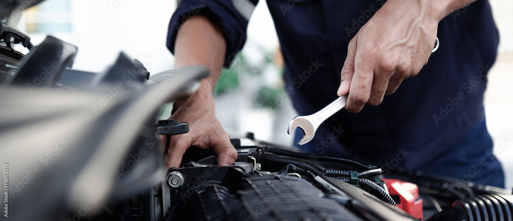 Mechanic are using the wrench to repair and maintenance auto engine at car repair shop,Car auto services and maintenance check concept. Mechanic are using the wrench to repair and maintenance auto engine at car repair shop,Car auto services and maintenance check concept.