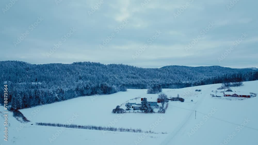 Buildings Isolated In Winter Nature Landscape Surrounded By Forested Mountains. Aerial Drone Shot Buildings Isolated In Winter Nature Landscape Surrounded By Forested Mountains. Aerial Drone Shot
