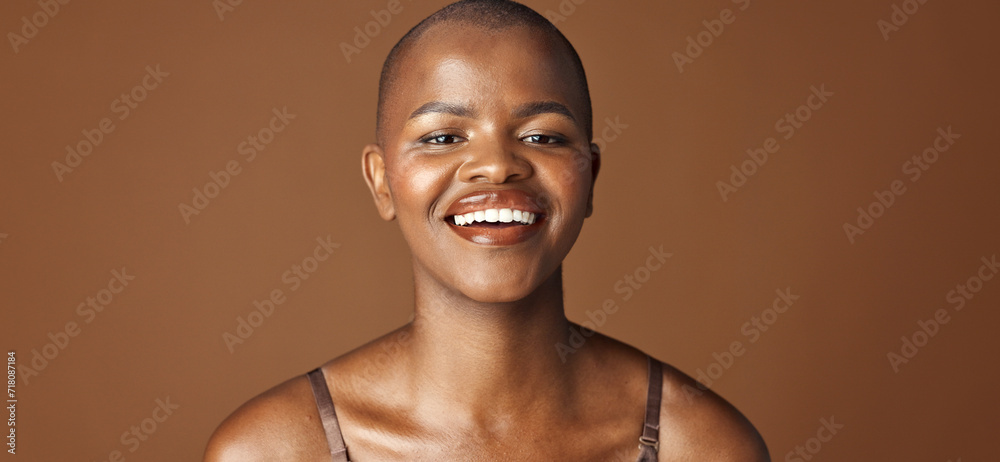 Face, beauty and smile with happy black woman in studio isolated on brown background for wellness. Portrait, skincare and aesthetic for foundation cosmetics or dermatology with a natural bald person - obrazy, fototapety, plakaty 