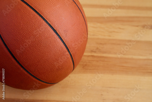 A basketball ball close-up on a wooden floor. Sports background, basketball background