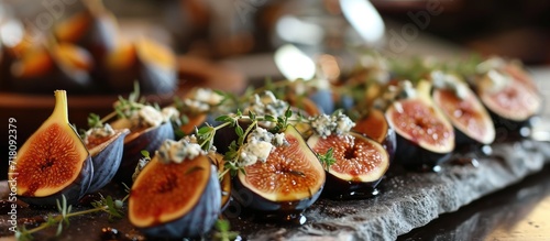 The platter was beautifully arranged, showcasing the vibrant colors of the figs stuffed with blue cheese and thyme, perfectly seasoned with a drizzle of sweet honey. photo