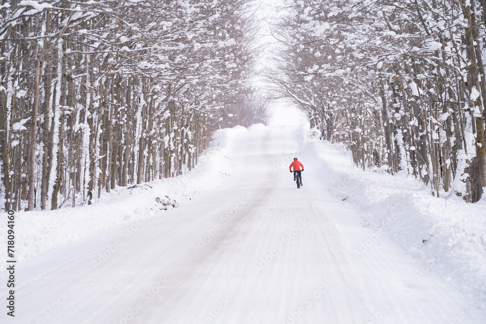 Fat biker riding his bicycle in the snow during Canadian winter