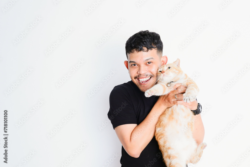 a young asian man hugging a tabby cat, on a white background a young asian man hugging a tabby cat, on a white background