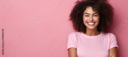 Happy young woman smiling at camera on solid pastel background with space for text placement