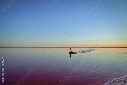 kite surfing on pink lake at sunset
