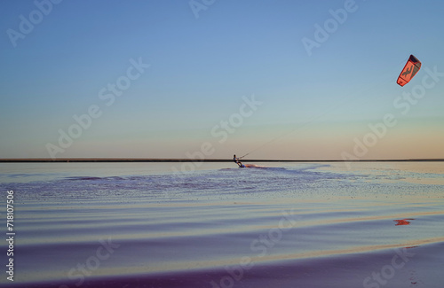 kite surfing on pink lake at sunset