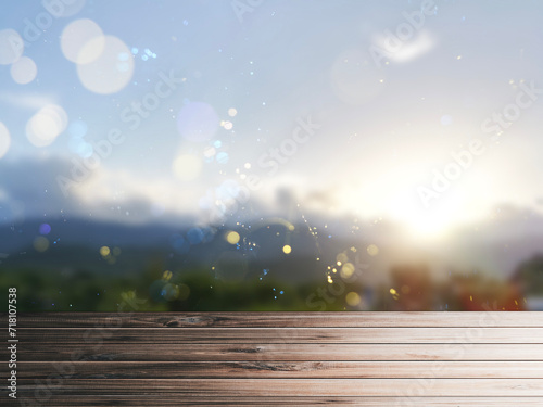 Wooden table pattern, blurred mountain background with evening bokeh lights, use for graphic design. © Nuttawut
