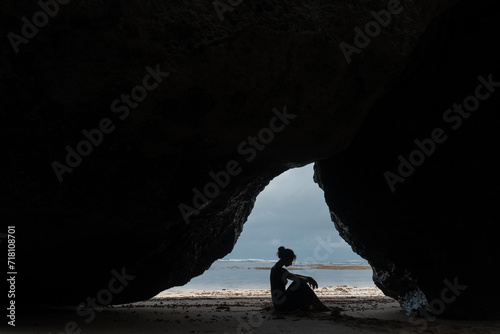 Wallpaper Mural Outline of a girl posing against the backdrop of the ocean among the rocks Torontodigital.ca