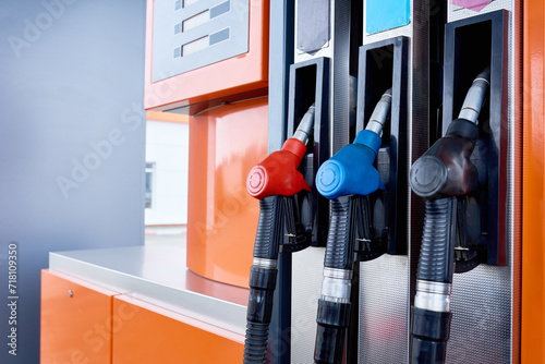 Close up background image of fuel pump with several nozzles in gas station, copy space photo