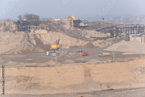 Environmental pollution, a large crushed stone quarry. A stone crushing machine for the production of crushed stone, sand and gravel in an open manner. Industrial landscape.