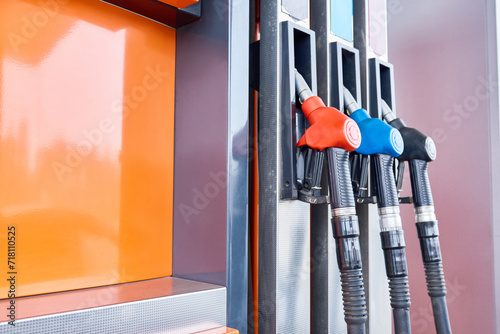 Background image of tech fuel pump with nozzles at petrol station, copy space photo
