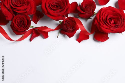 Fototapeta Naklejka Na Ścianę i Meble -  Beautiful red roses, petals and ribbon on white background, flat lay. Space for text