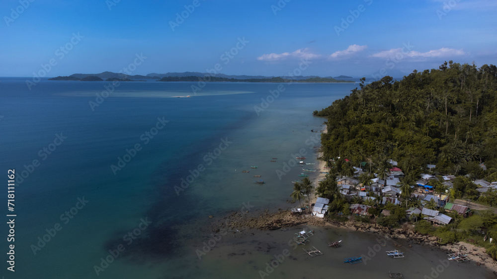 Aerial view over Port Barton Harbour in Palawan, the Philippines, on a sunny morning. blue seas and skies.