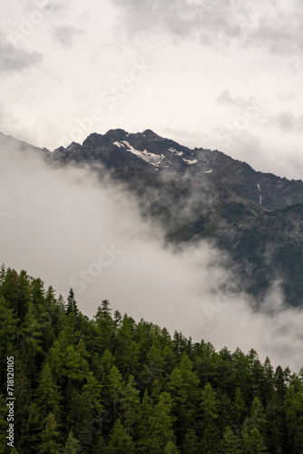 Clouds low in the valley over a forest in the mountains © Marek