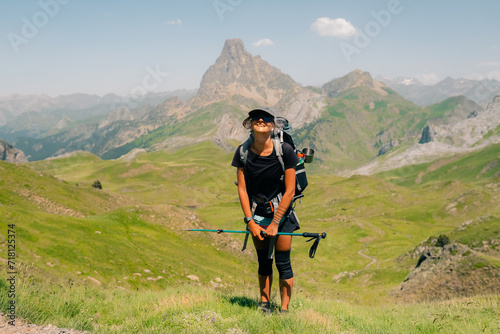 hiker and view of Pic d'Ossau in the French Pyrenees National Park. Ossau Valley, Pyrenees National Park, Pyrenees, France.