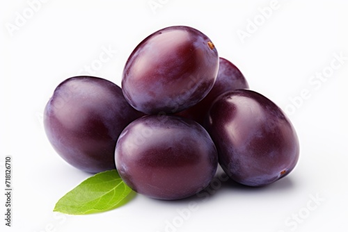 purple plum isolated on a white background. violet fruit, a bunch of berries with leaves.