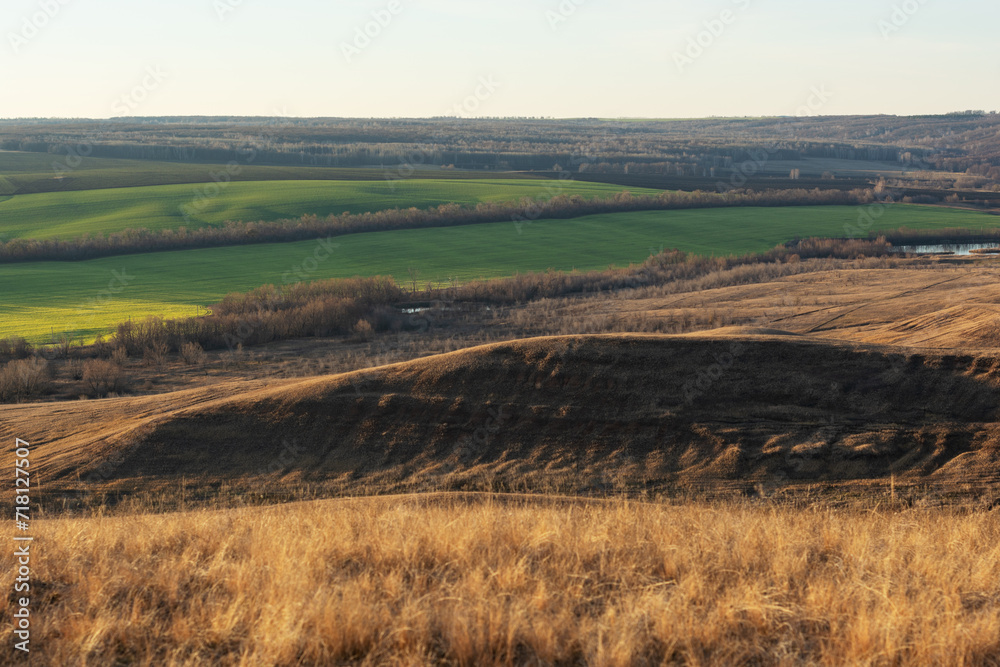 Panoramic view of the rural landscape from a hill at sunset or dawn.
