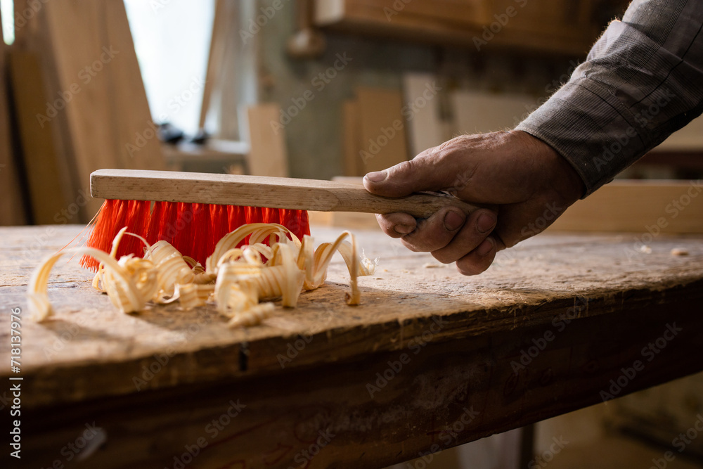 Carpenter's work. Wood shavings, chip. Sweep wood shavings from the ...