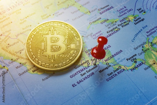 A red pin is pinned on the world map of El Salvador and there is a bitcoin next to it.