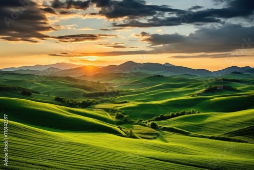 Beautiful sunset at summer day. View from the top of the hill. Green fields and trees. Generative AI. © Penatic Studio