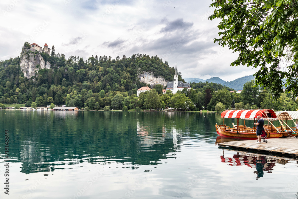 Lake Bled Slovenia. Beautiful mountain lake with small Pilgrimage Church. Most famous Slovenian lake and island Bled with Pilgrimage Church of the Assumption of Maria and Bled Castle in background. Lake Bled Slovenia. Beautiful mountain lake with small Pilgrimage Church. Most famous Slovenian lake and island Bled with Pilgrimage Church of the Assumption of Maria and Bled Castle in background.