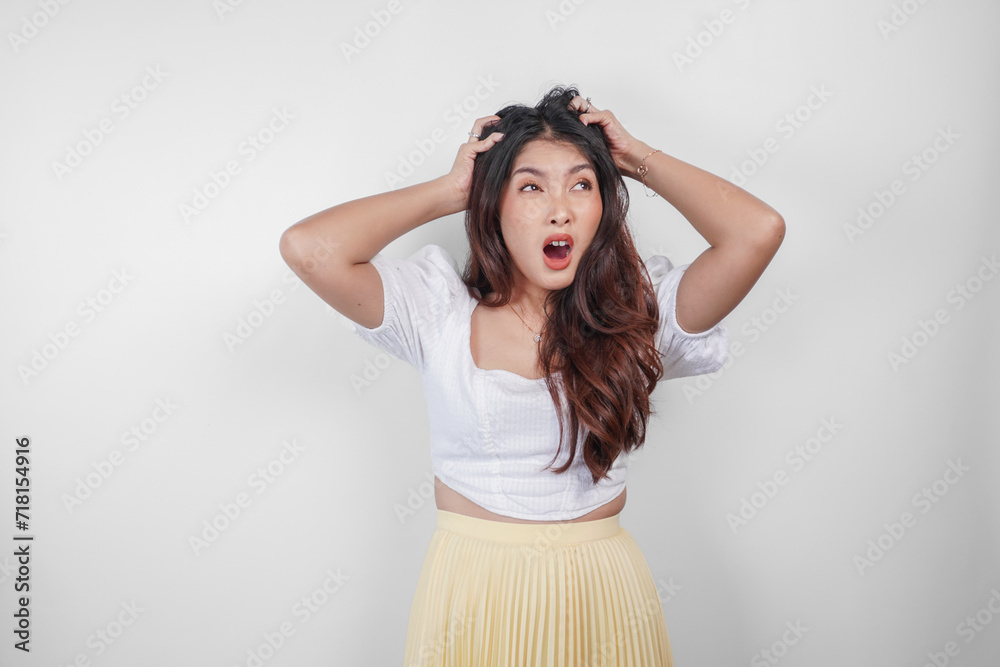 Naklejka premium A sad Asian woman looks stressed and depressed, isolated white background.