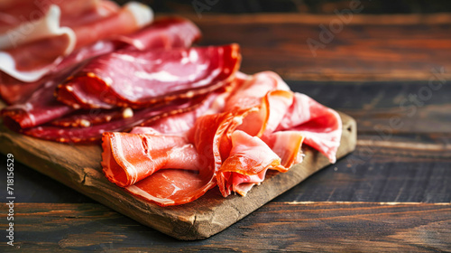 Wooden Cutting Board Piled With Farm-produced Ham, A Delicious Display of Expertly Cured Meat.
