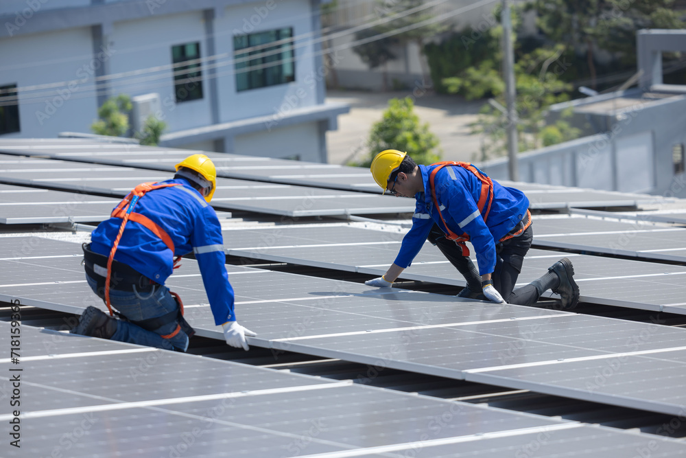 Engineer checking on solar panel on the factory rooftop Engineer checking on solar panel on the factory rooftop