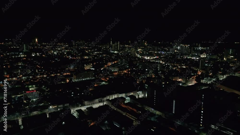 Night illuminated flight over a big city traffic aerial top down panorama 4k. Night evening roads of the city full of traffic Night illuminated flight over a big city traffic aerial top down panorama 4k. Night evening roads of the city full of traffic