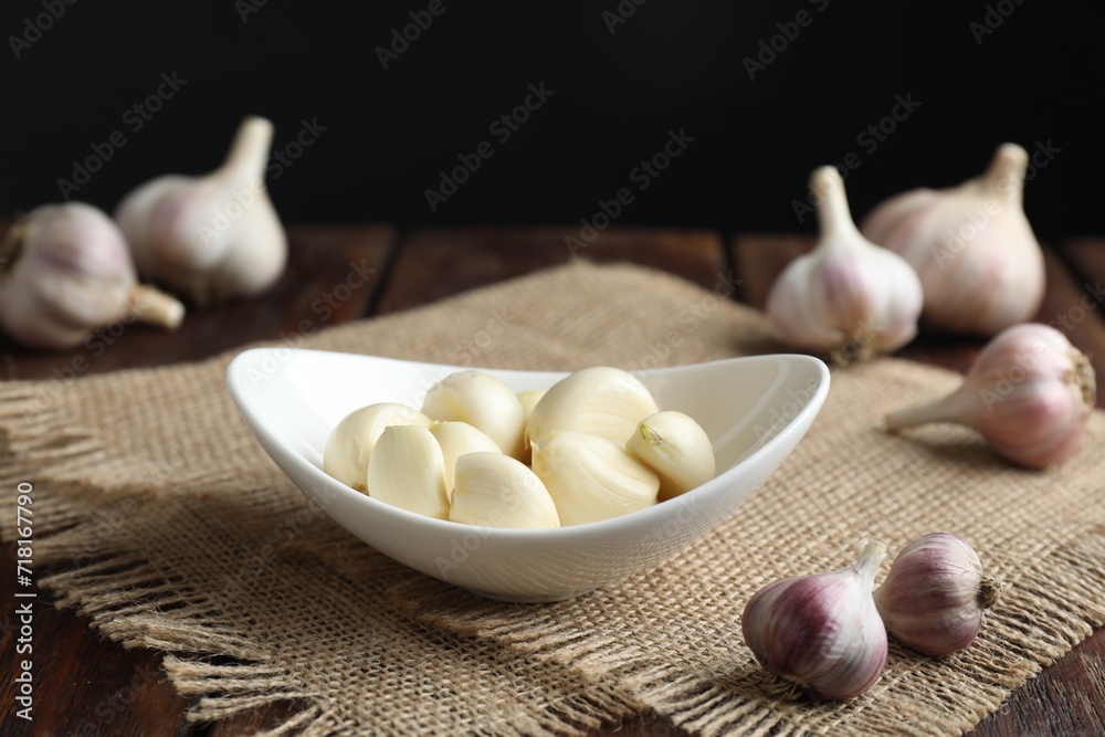 Fresh garlic cloves and bulbs on wooden table Fresh garlic cloves and bulbs on wooden table