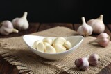 Fresh garlic cloves and bulbs on wooden table