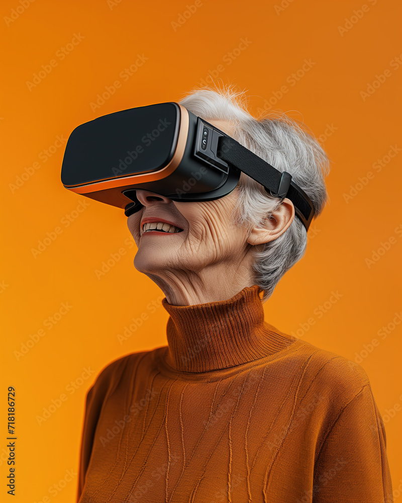 side view of happy senior woman in VR goggles smiling while experiencing another world against orange background side view of happy senior woman in VR goggles smiling while experiencing another world against orange background