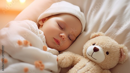 cute newborn baby girl lying in the bed with a teddy bear on a white soft blanket.