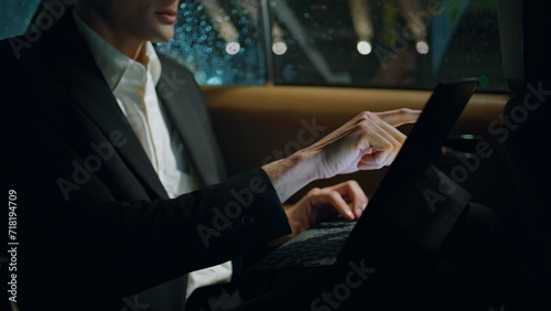 Businessman hand tapping tablet screen car closeup. Manager working pad device