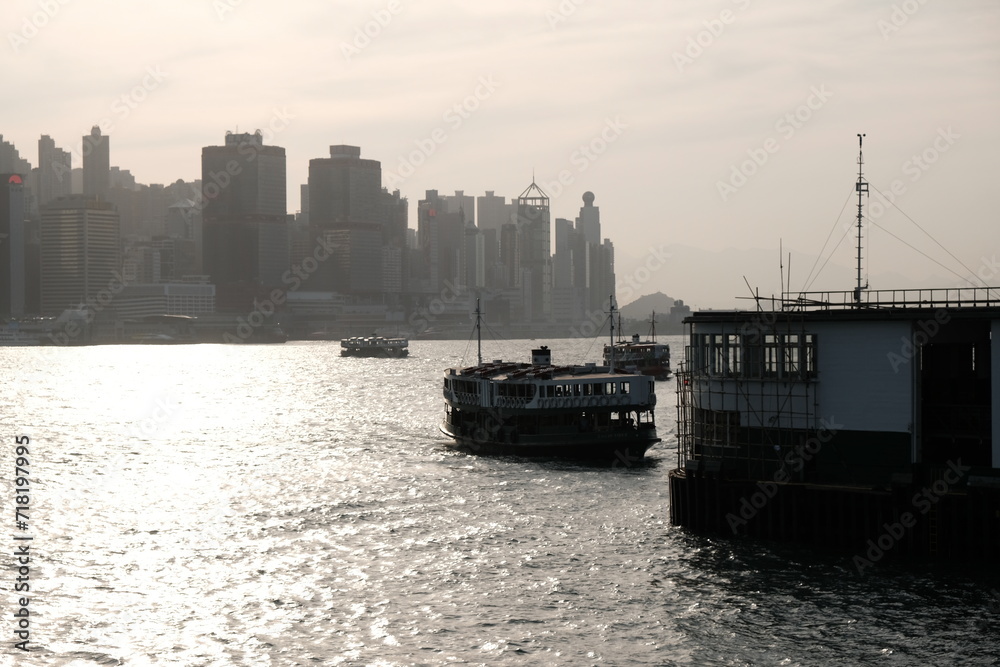 Naklejka premium sunset over the city, harbour, ferry